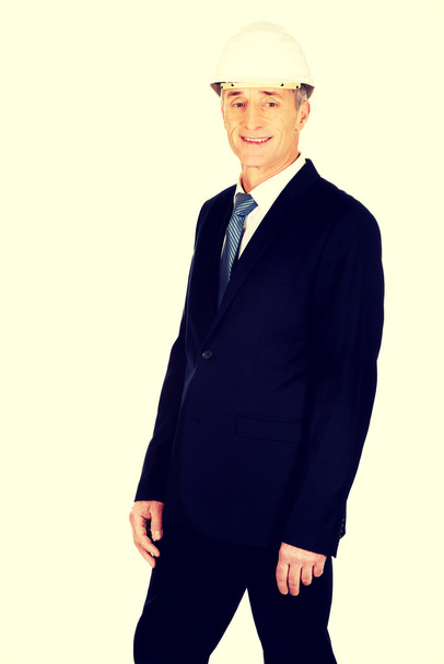 Smiling businessman with hard hat - Fotó, kép