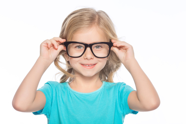 Little girl trying on glasses. - 写真・画像