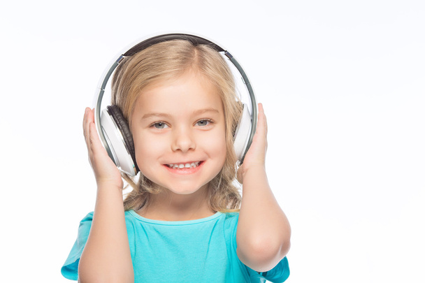 Little girl wearing headphones. - Φωτογραφία, εικόνα