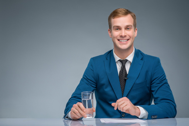 Smiling newscaster during broadcasting. - Fotoğraf, Görsel