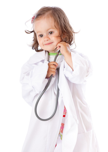 A little girl is playing as a doctor - Φωτογραφία, εικόνα