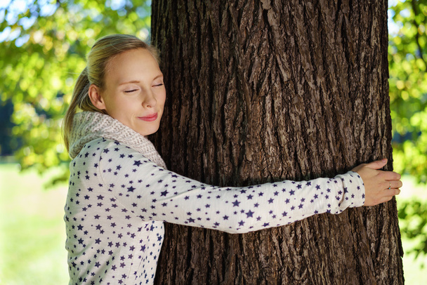 Thoughtful Woman Hugging Tree Trunk at the Park - Photo, Image