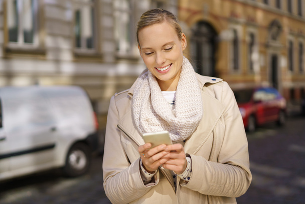 Woman Messaging Someone by Phone at the Street - Valokuva, kuva