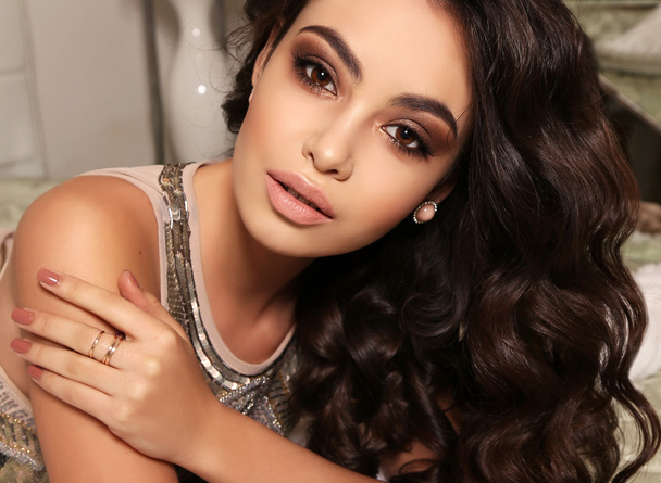 beautiful woman with dark curly hair and evening makeup  - Foto, Imagen