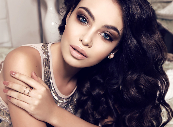 beautiful woman with dark curly hair and evening makeup  - Zdjęcie, obraz