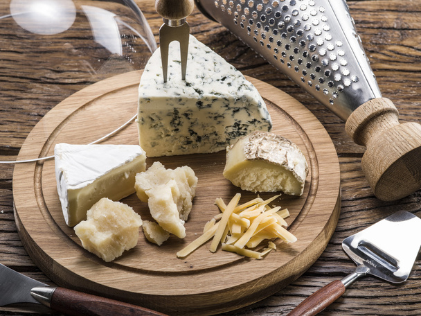 Variety of cheeses. Vintage stiles. - Фото, изображение
