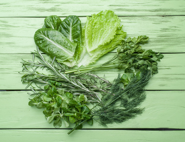 Green herbs on the green wooden background. - Photo, Image