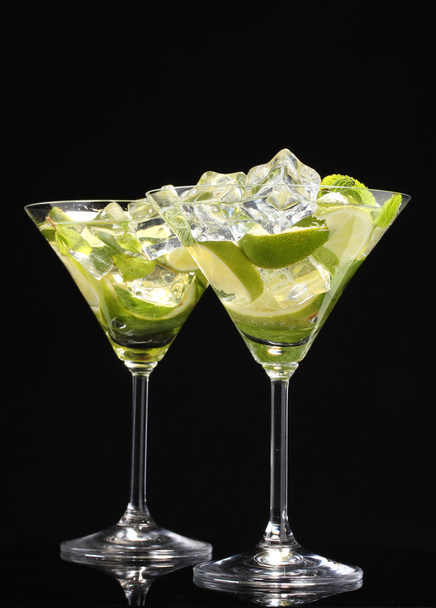 Glasses of cocktails with lime and mint on black background - Fotografie, Obrázek