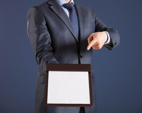 Businessman with clipboard with blank paper - 写真・画像