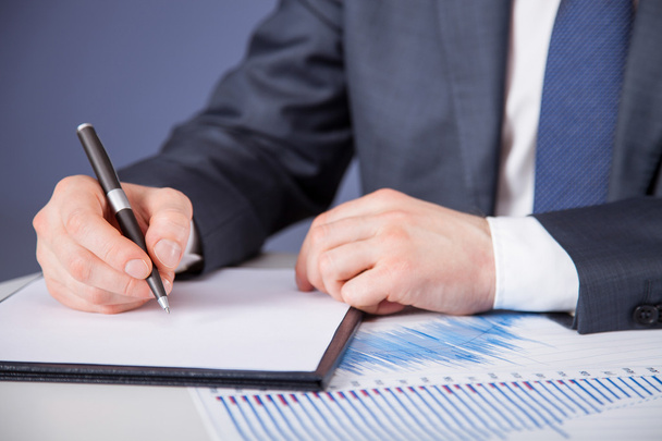 Businessman signing a document - Photo, image