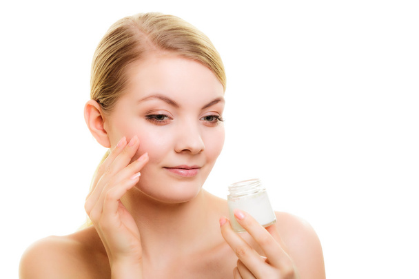 Skin care. Girl applying moisturizing cream. - Foto, Imagen