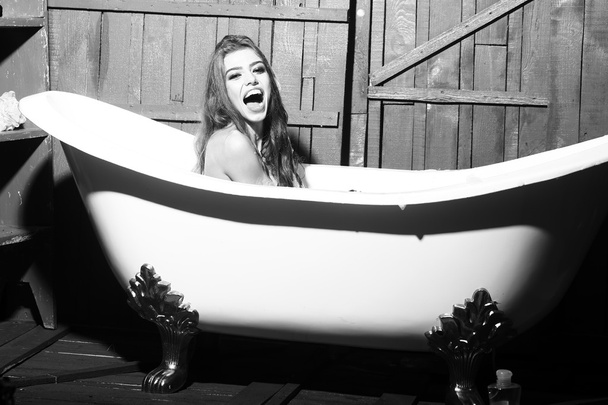 Laughing woman in bath - Фото, зображення