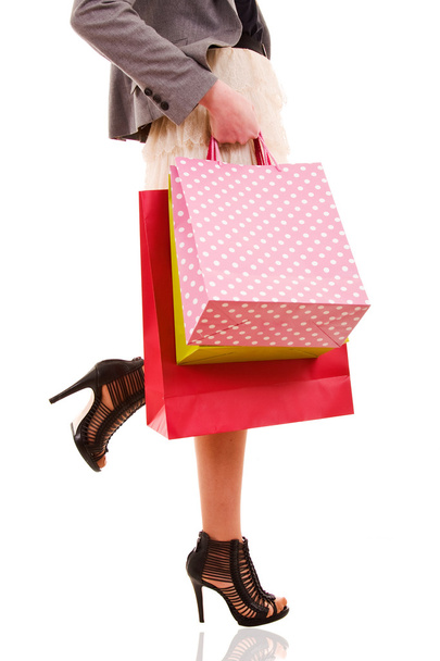 Waist-down view of woman carrying shopping bags - Фото, зображення