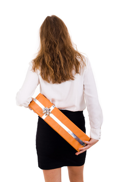 Business woman holding a gift on her back, isolated on white - Fotografie, Obrázek