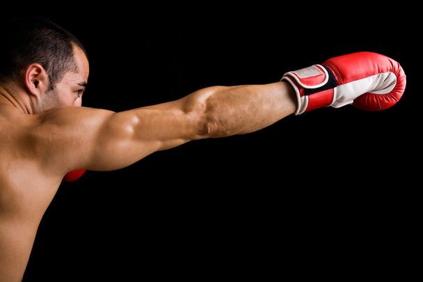 Young Boxer fighter over black background - Фото, изображение