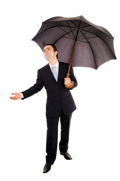 A businessman holding an umbrella and checking if it rains. Isol - Foto, afbeelding