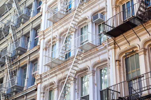 old buildings with fire escape stairs in Soho, NYC - 写真・画像