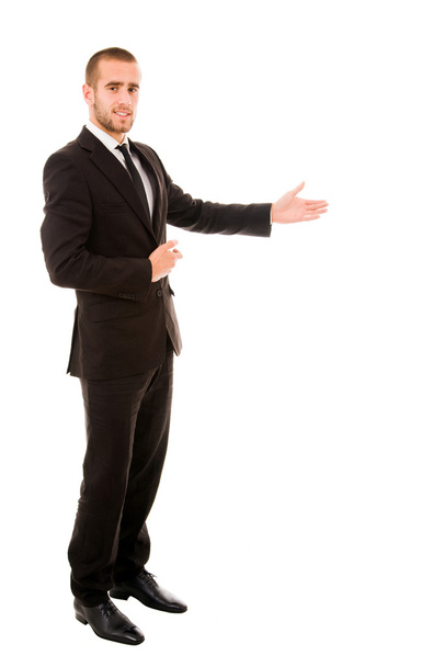 Happy businessman with arm out in a welcoming gesture , isolated - Фото, изображение