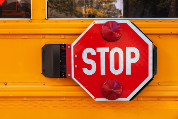 stop sign at a yellow school bus in Manhattan, NYC - Φωτογραφία, εικόνα