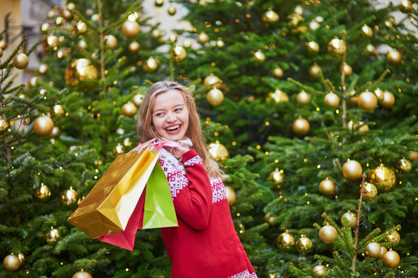 Cheerful young girl with colorful shopping bags - Photo, Image