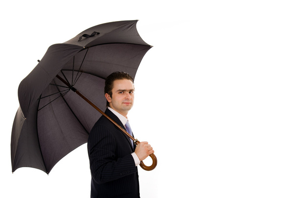 Young business man with an umbrella against white background - Фото, зображення
