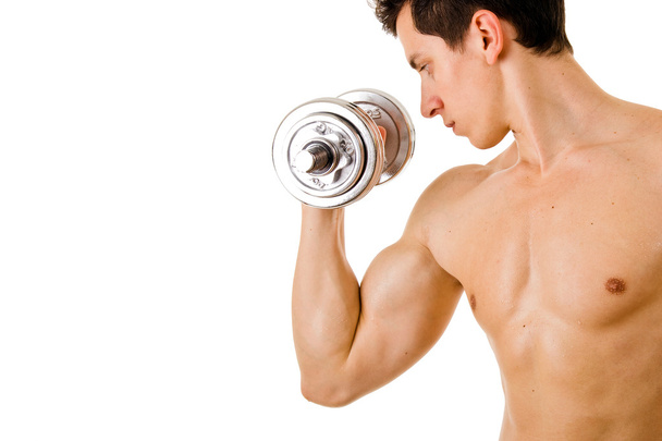 Powerful muscular young man lifting weights - Photo, image