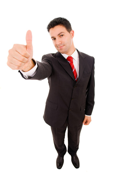 Happy young business man showing thumbs up sign against white ba - Photo, image