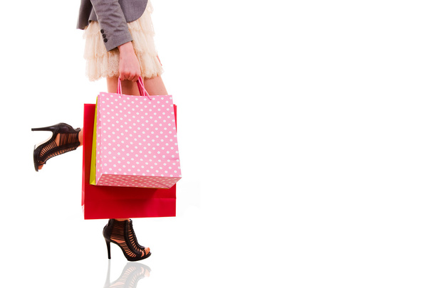 Waist-down view of woman carrying shopping bags, isolated on whi - Photo, Image