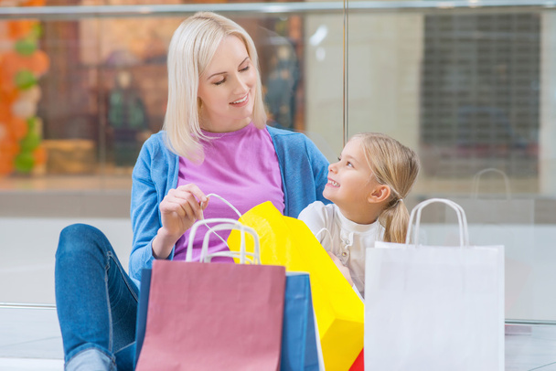 Cheerful mother and daughter having shopping - Fotografie, Obrázek