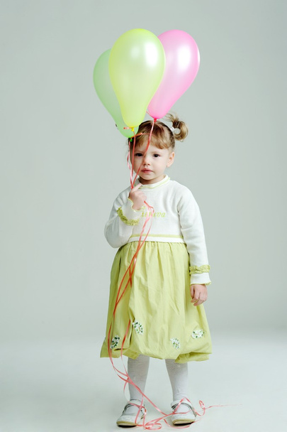 A portrait of a nice little girl with three balloons - Foto, Imagen