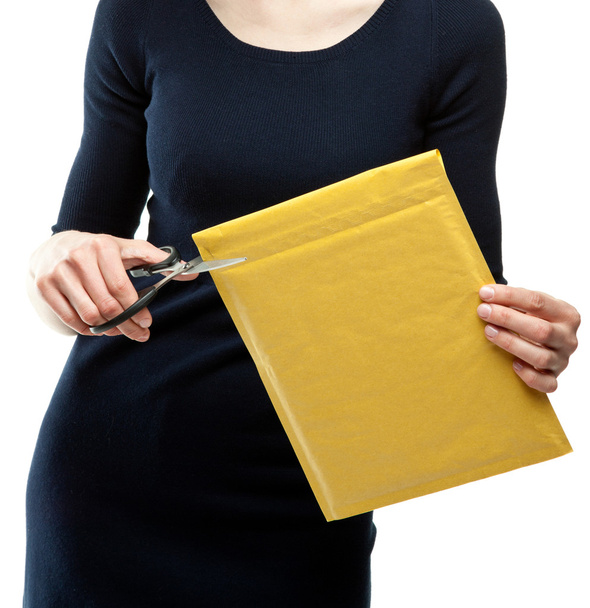 woman cutting parcel with scissors - Foto, immagini