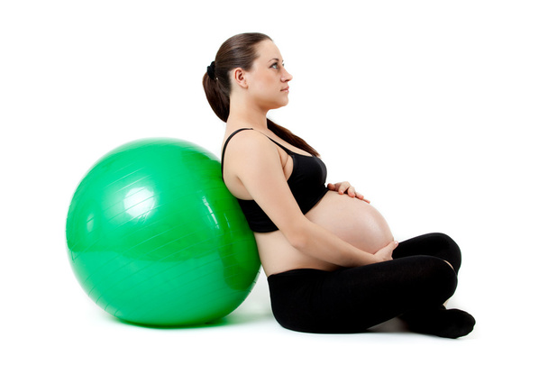 Pregnant woman excercises with gymnastic ball. Beautiful pregnan - Foto, afbeelding