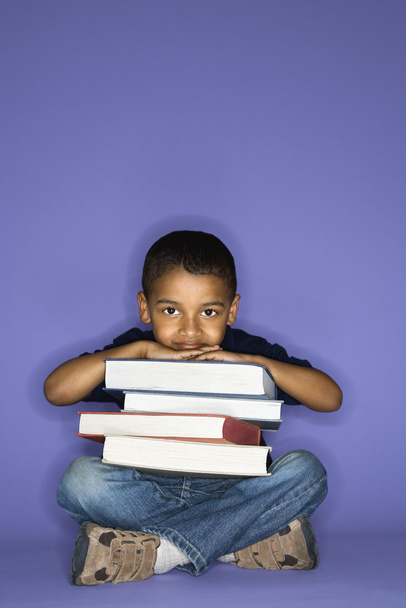 Boy sitting with books. - Zdjęcie, obraz