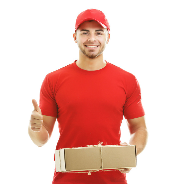 Delivery man holding package - Foto, afbeelding