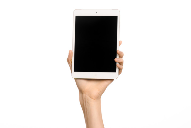Presentation and advertising touchscreen topic: human hand holding a white tablet touch computer gadget with touch blank black screen isolated on a white background in studio - Foto, Imagen