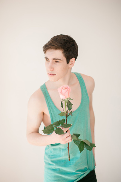 Handsome young man with pink rose - Fotografie, Obrázek