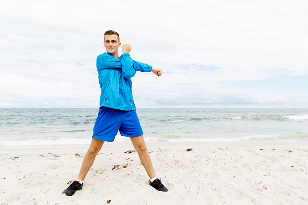 Man training on beach outside - Photo, Image
