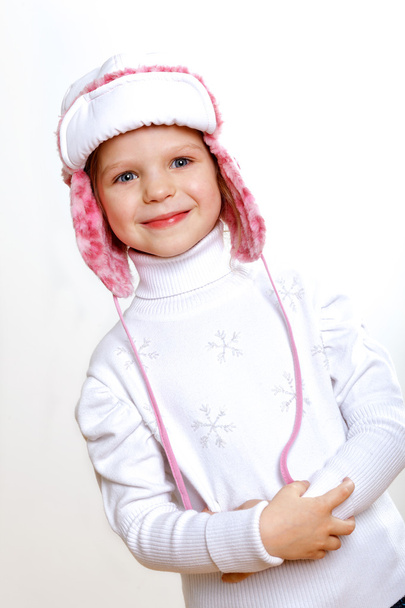 Kid in winter wear against white background - Foto, immagini