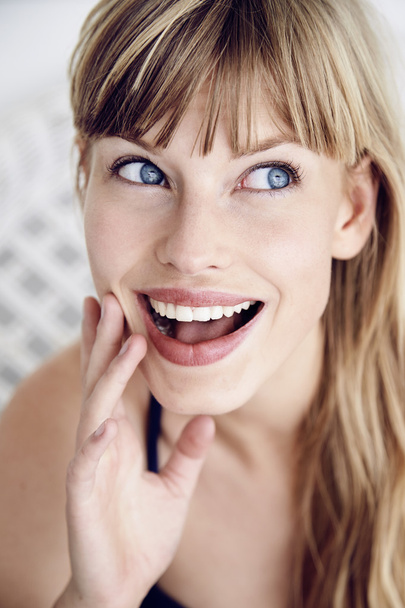 Excited young blue eyed woman - 写真・画像