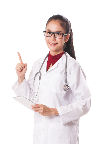 female doctor using a digital tablet and pointing up on white background. - Foto, afbeelding