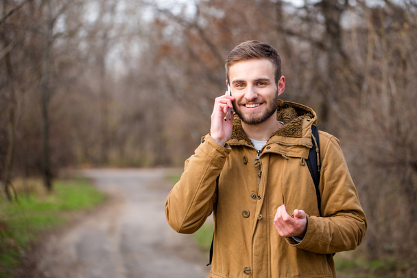 Man talking on the phone outdoors - Fotó, kép