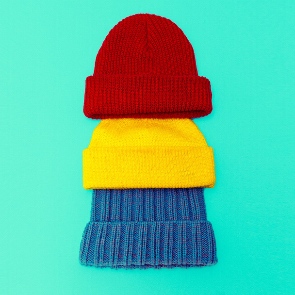 Set Stylish knitted cap on blue background - Foto, afbeelding