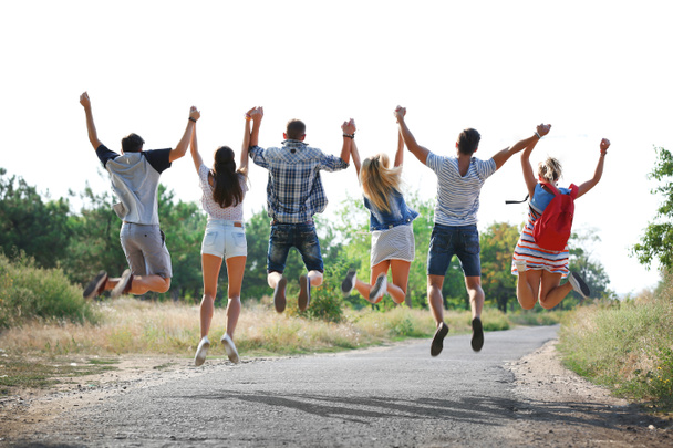 Happy friends jumping together, outdoors - Photo, Image