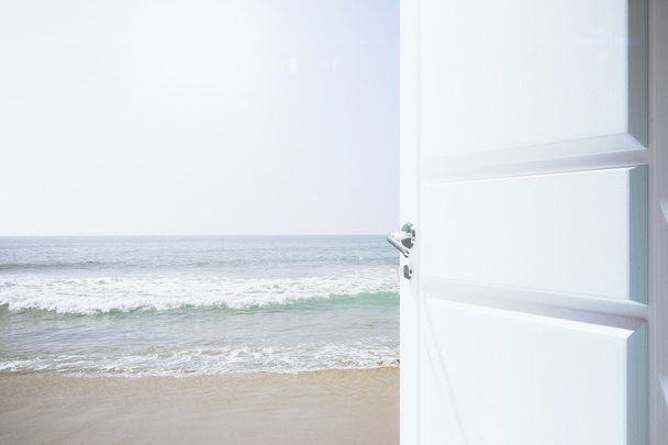 Opened white door to a beachway with ocean - Fotoğraf, Görsel