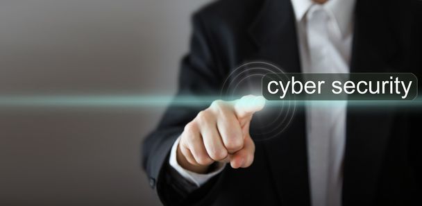 Businessman's hand pressing the icon with text "cyber security" on virtual screens. Business, technology, internet and networking concept. Copy space - Photo, Image