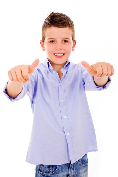 Portrait of a smilling cute little boy gesturing thumbs up sign - 写真・画像