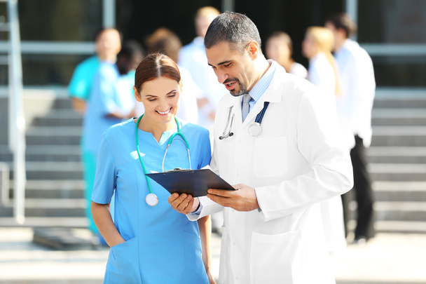 Medical concept - two doctors with stethoscopes and prescription clipboard - Fotoğraf, Görsel