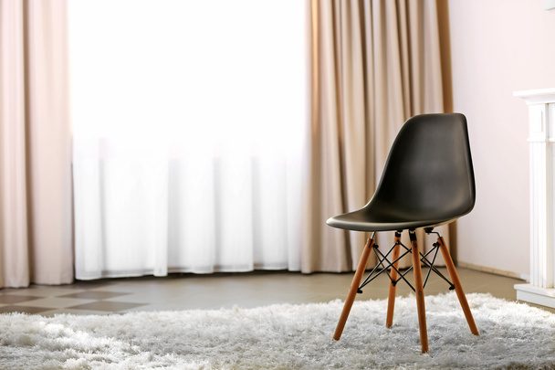 Stylish conception with black chair on light room background - Foto, Bild