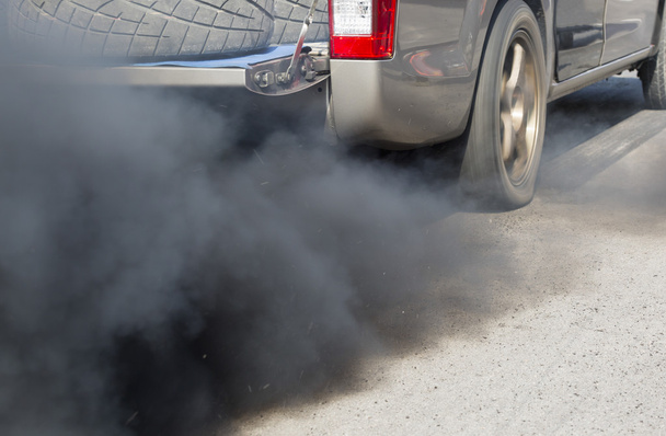 Air pollution from vehicle exhaust pipe on road - Photo, Image