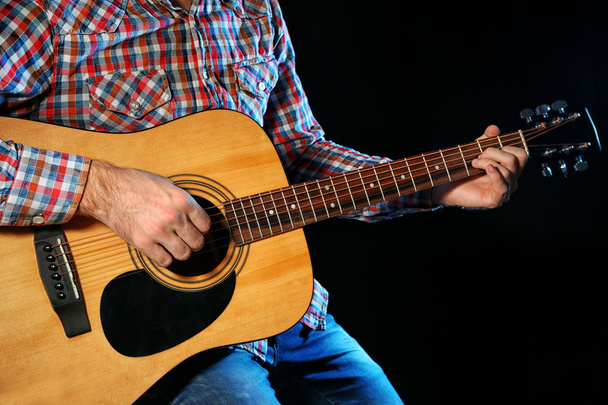 Young man playing on guitar  - Foto, Imagen